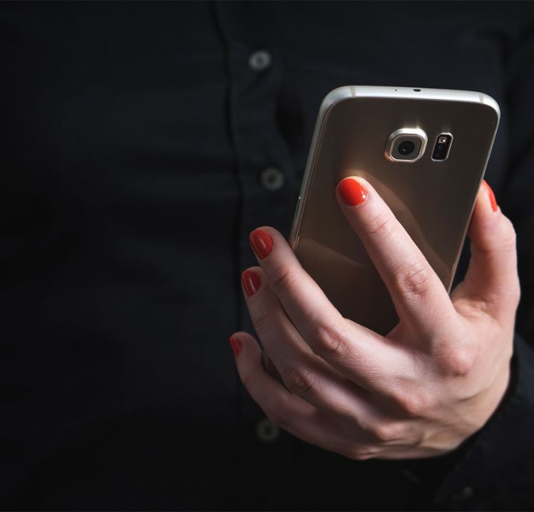 Contact The Affinia Group womans hand holding mobile phone